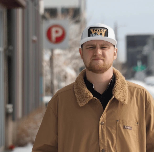 Tayco Farms team member wearing a branded cap outdoors