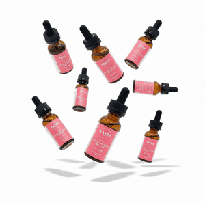 Set of TAYCO skincare bottles with pink labels on a white background