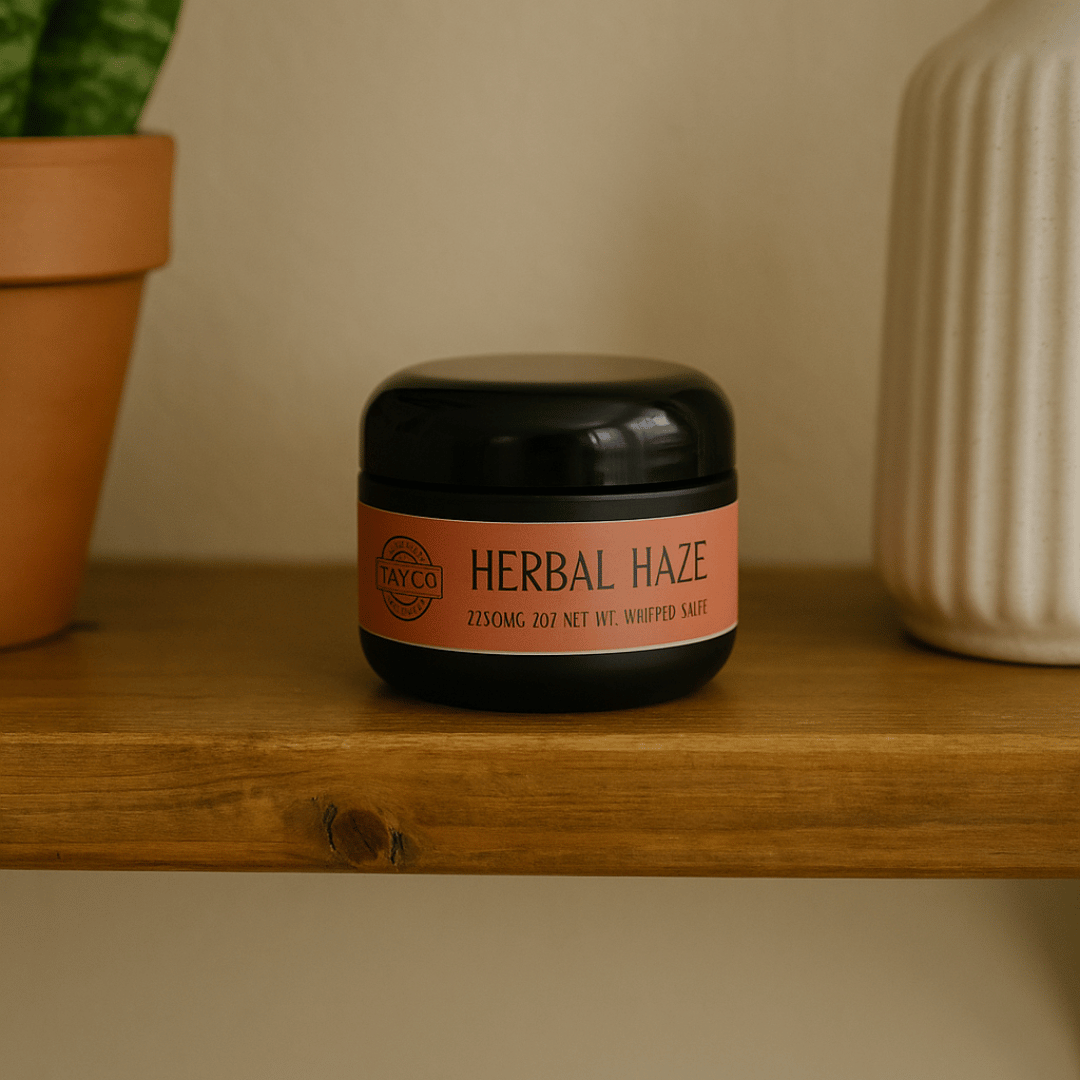 Jar of 'Herbal Haze' on a wooden shelf with a plant and vase in the background