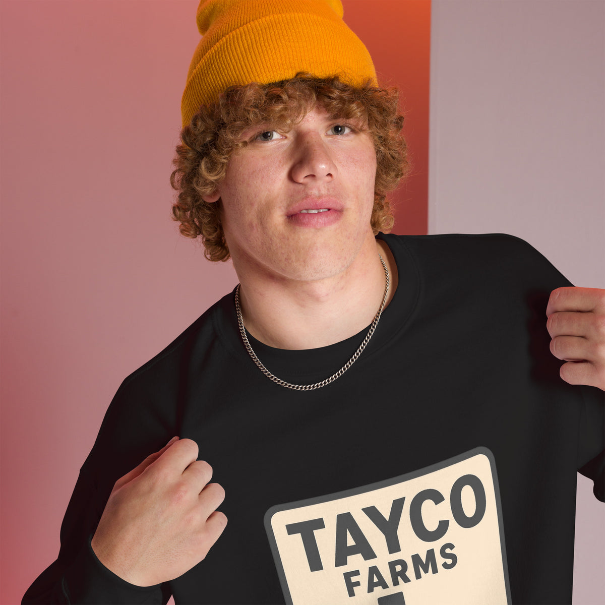 Close-up of a person wearing a black Tayco Farms Texas Drip sweatshirt