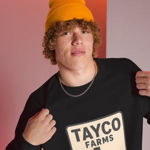 Close-up of a person wearing a black Tayco Farms Texas Drip sweatshirt