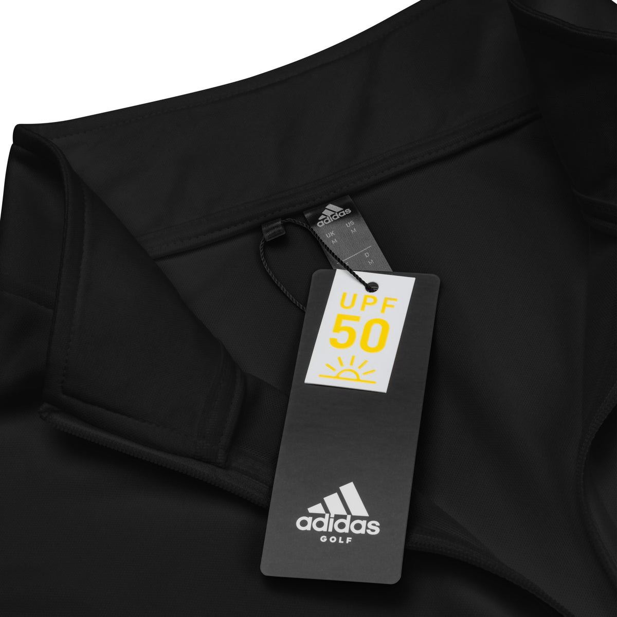 Clothing detail of a black Tayco Farms Adidas quarter-zip pullover