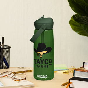 Tayco Farms forest green water bottle beside a notebook