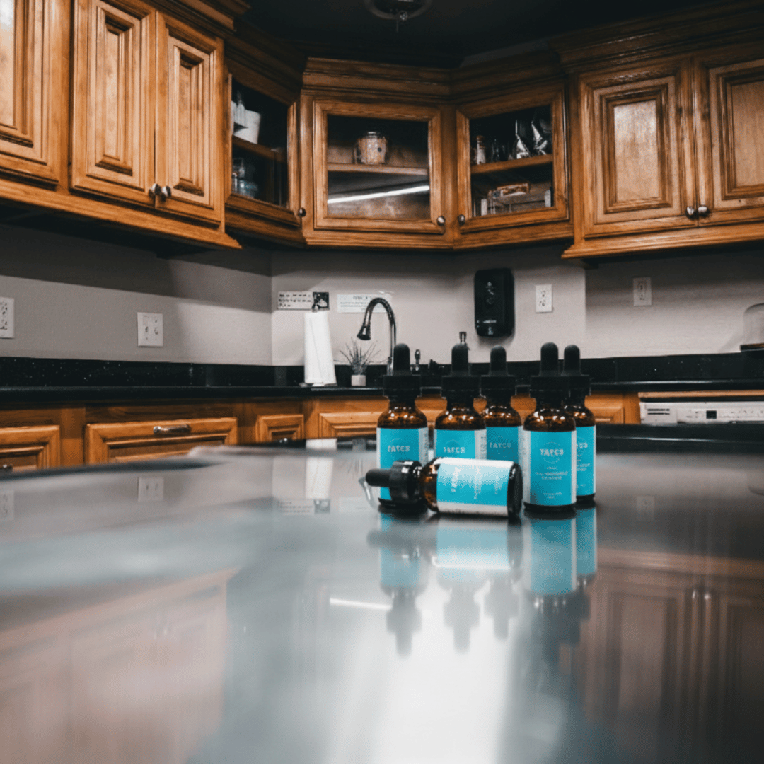 Tayco Farms full spectrum CBD tincture bottles on a kitchen counter