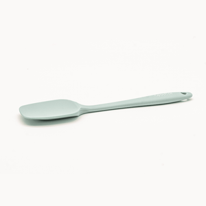 Pale green CannaFuse mixing spoon on white