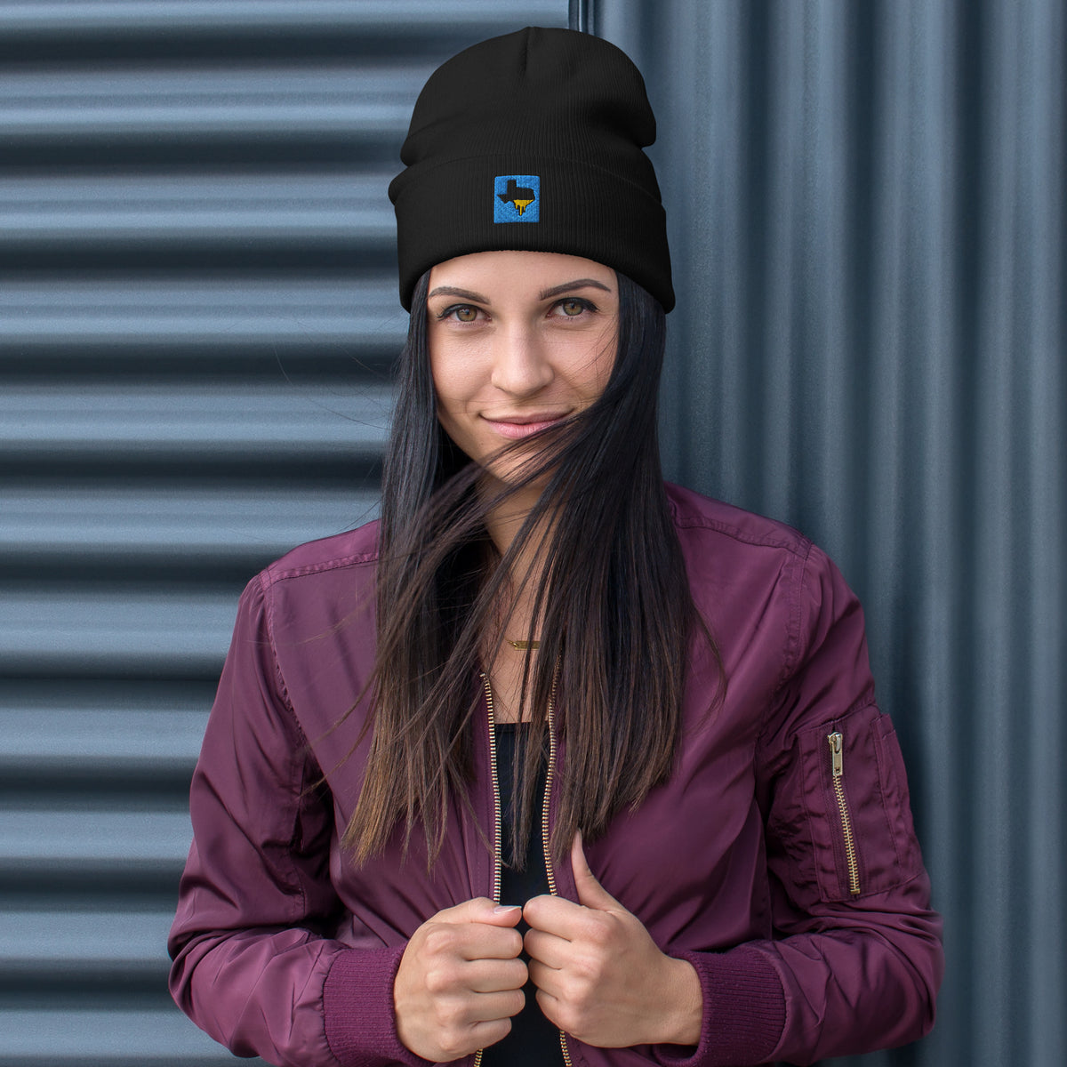 Person wearing a black Tayco Farms embroidered Texas logo beanie