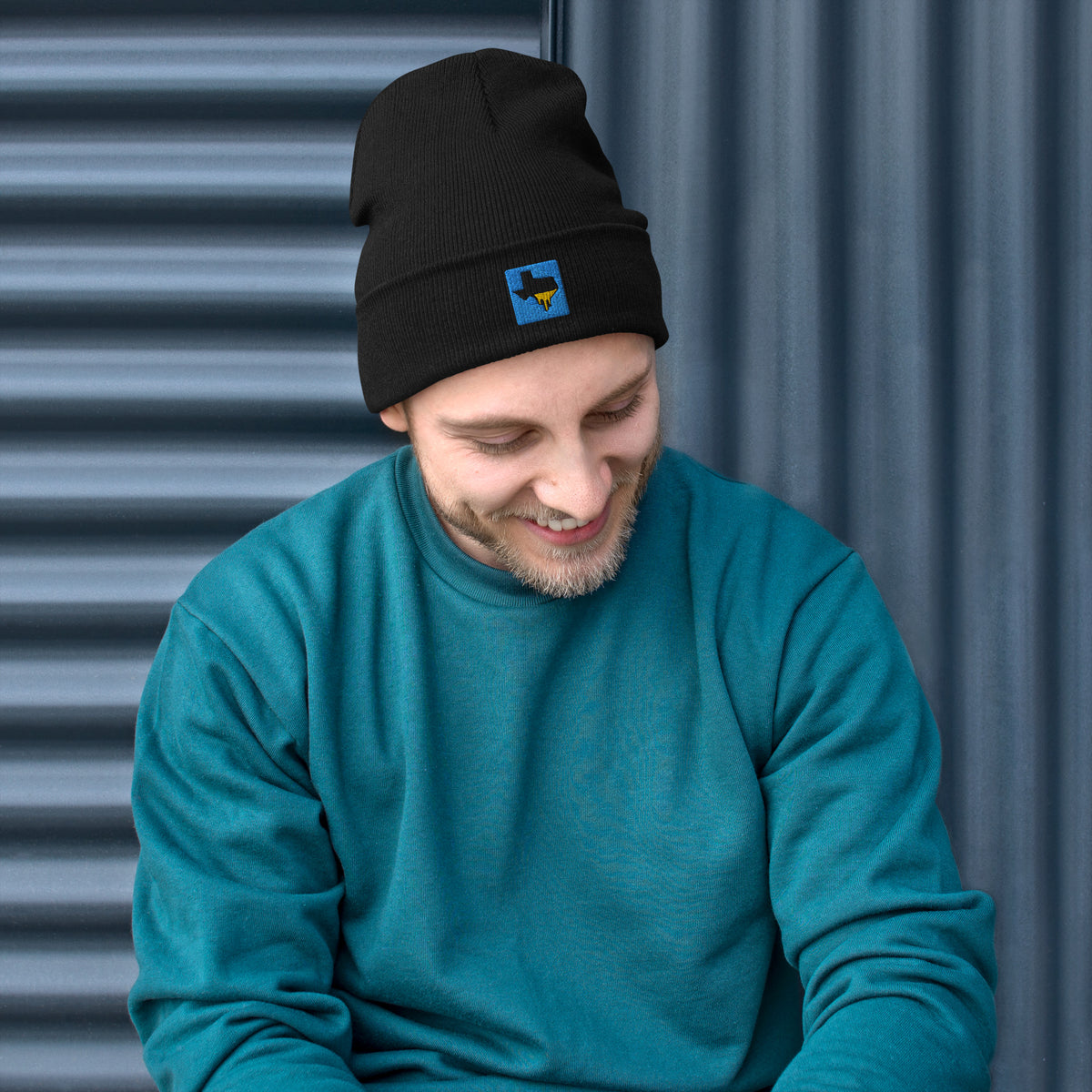 Person wearing a black Tayco Farms embroidered Texas logo beanie