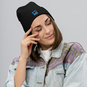 Person wearing a black Tayco Farms embroidered Texas logo beanie