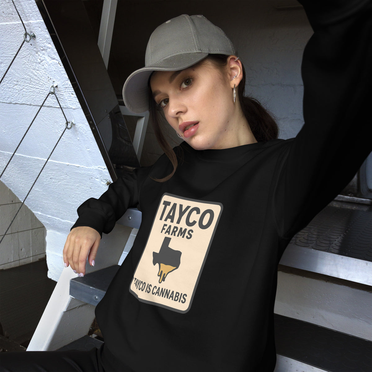 Woman wearing a black Tayco Farms Texas Drip sweatshirt